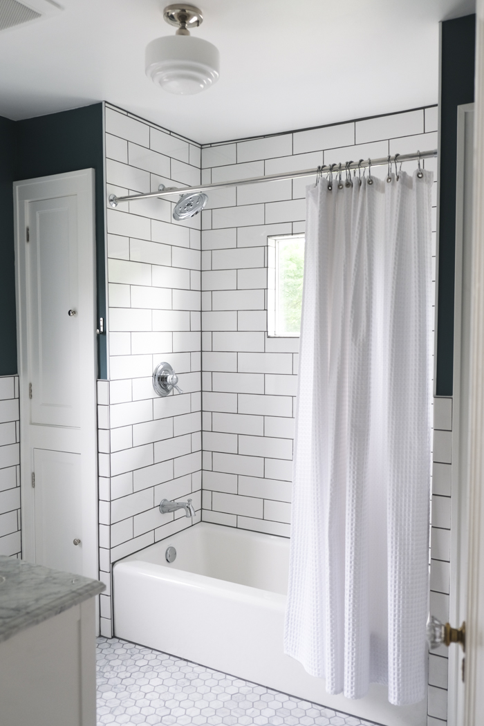 https://bedknobsandbaubles.com/wp-content/uploads/2022/06/Classic-Bathroom-with-Subway-Tile-and-Marble-Floors-1-2.jpg